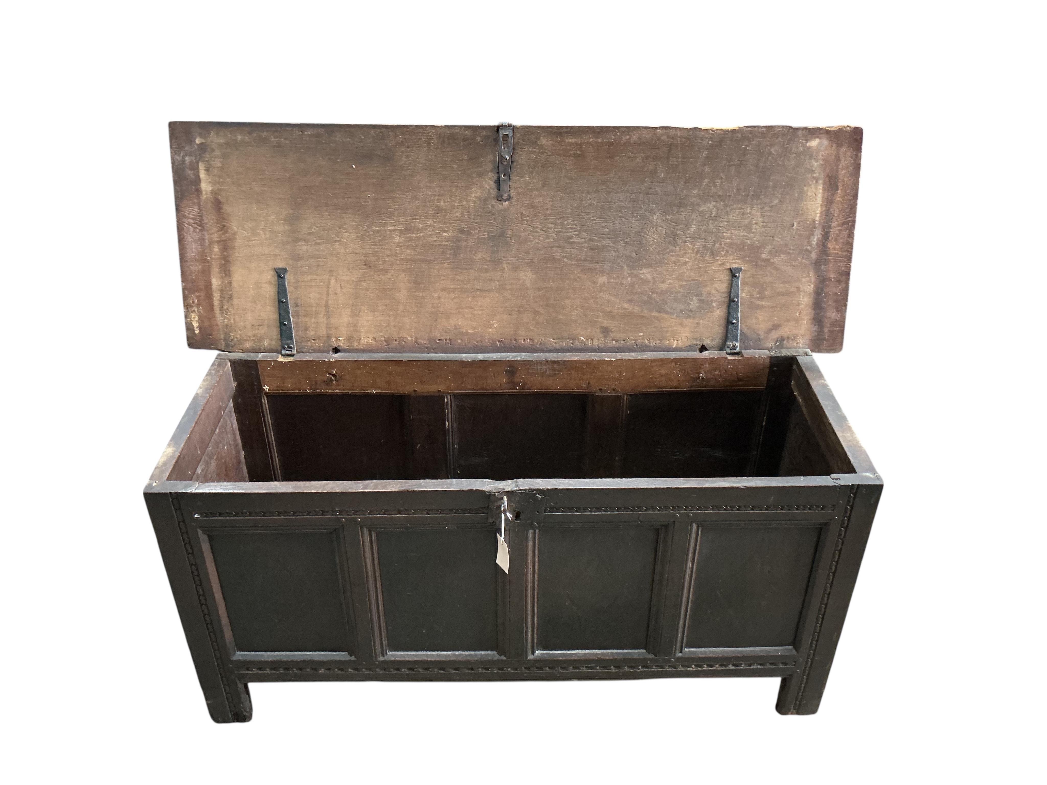 An 18th century panelled oak coffer, width 138cm, depth 46cm, height 64cm